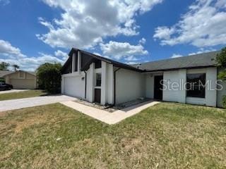 116 Talavera Ln, Kissimmee, FL 34758 - view of front of home featuring driveway, a front yard, an attached garage, and stucco siding