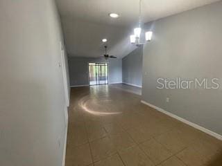 116 Talavera Ln, Kissimmee, FL 34758 - unfurnished room featuring baseboards, recessed lighting, vaulted ceiling, tile patterned flooring, and a chandelier