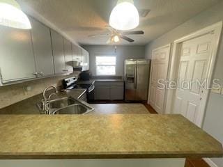 116 Talavera Ln, Kissimmee, FL 34758 - kitchen with appliances with stainless steel finishes, a sink, a ceiling fan, and gray cabinets