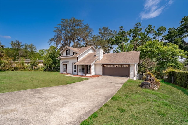 traditional-style house with an attached garage, driveway, a front yard, a chimney, and a shingled roof