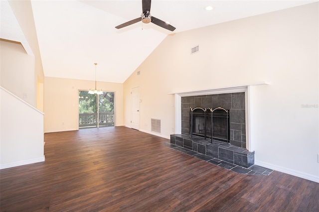 unfurnished living room with dark wood finished floors, a chandelier, high vaulted ceiling, ceiling fan, and baseboards