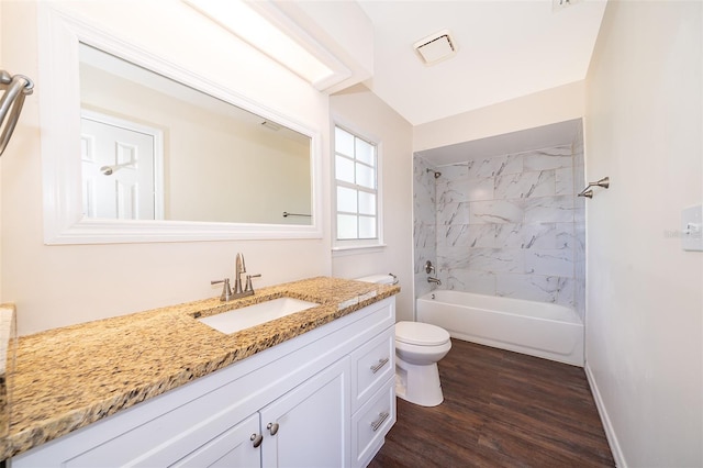 bathroom with vanity, toilet, wood finished floors, and shower / tub combination