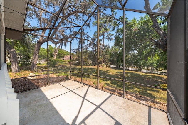 unfurnished sunroom with view of scattered trees