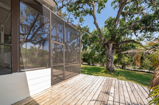 wooden terrace featuring a lawn
