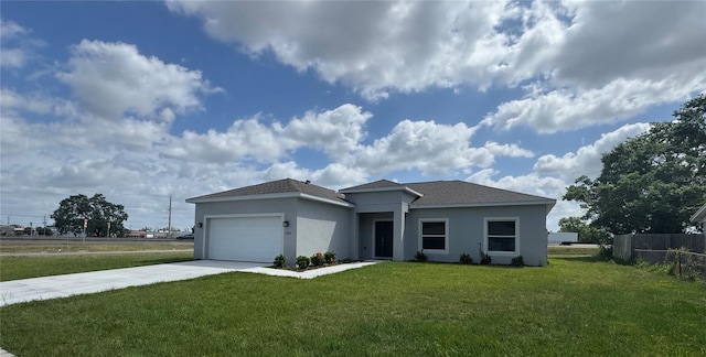 2427 Continental Blvd, Orlando, FL 32808 - view of front facade with stucco siding, driveway, and a garage