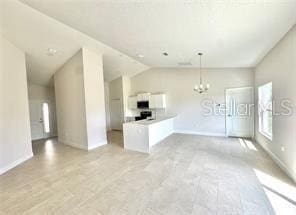 2427 Continental Blvd, Orlando, FL 32808 - unfurnished living room with a chandelier and baseboards