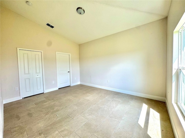 2427 Continental Blvd, Orlando, FL 32808 - unfurnished bedroom with lofted ceiling and baseboards