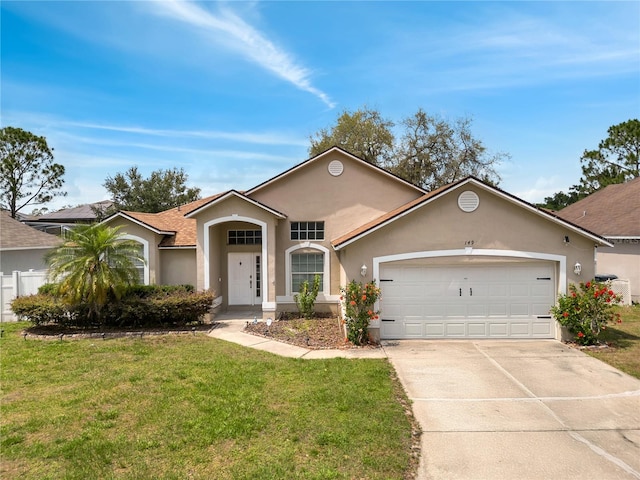 149 Imperial Oak Ct, Davenport, FL 33896 - view of front of house with stucco siding, an attached garage, driveway, and a front yard