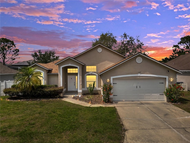 149 Imperial Oak Ct, Davenport, FL 33896 - view of front of property featuring stucco siding, concrete driveway, an attached garage, and a front yard