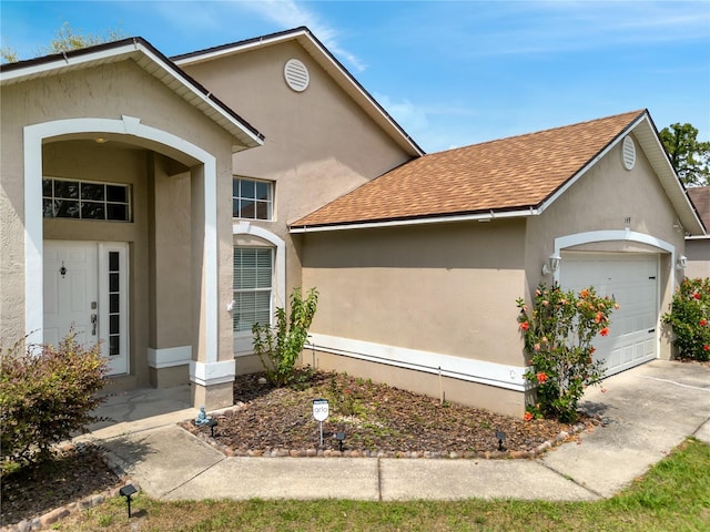 149 Imperial Oak Ct, Davenport, FL 33896 - view of front of property featuring roof with shingles, a garage, stucco siding, and driveway