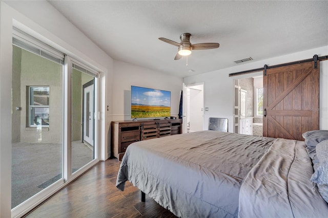 149 Imperial Oak Ct, Davenport, FL 33896 - bedroom featuring a barn door, wood finished floors, access to outside, and a ceiling fan
