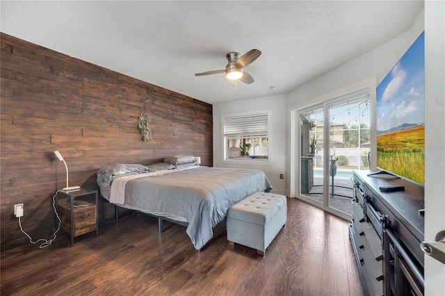 149 Imperial Oak Ct, Davenport, FL 33896 - bedroom with access to exterior, wood walls, dark wood finished floors, and ceiling fan