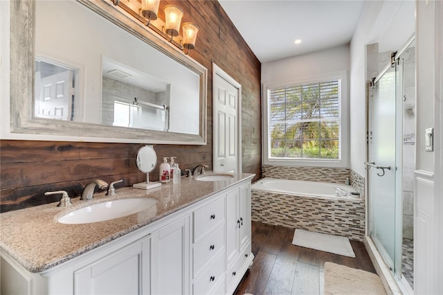 149 Imperial Oak Ct, Davenport, FL 33896 - bathroom featuring hardwood / wood-style floors, a shower stall, a garden tub, double vanity, and recessed lighting