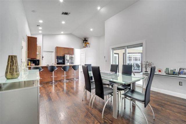 149 Imperial Oak Ct, Davenport, FL 33896 - dining area with high vaulted ceiling, dark wood-style floors, and recessed lighting