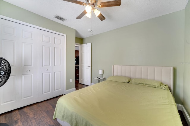 149 Imperial Oak Ct, Davenport, FL 33896 - bedroom featuring dark wood-style floors, a closet, ceiling fan, baseboards, and a textured ceiling