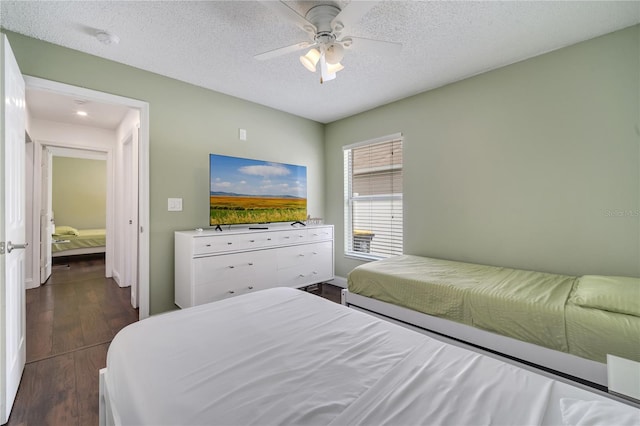 149 Imperial Oak Ct, Davenport, FL 33896 - bedroom with dark wood-style flooring, a ceiling fan, a textured ceiling, and baseboards