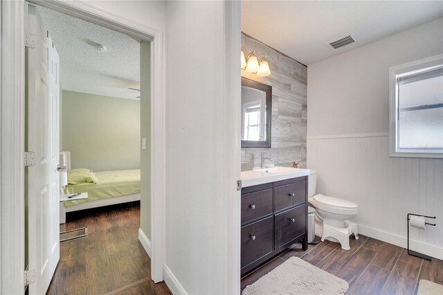 149 Imperial Oak Ct, Davenport, FL 33896 - bathroom featuring wood finished floors, toilet, vanity, and baseboards