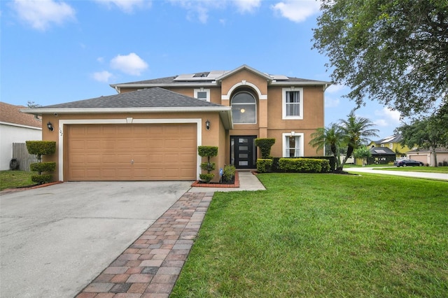 102 Royalty Cir, Sanford, FL 32771 - view of front of home featuring a front yard, driveway, stucco siding, an attached garage, and roof mounted solar panels