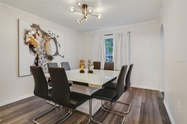 102 Royalty Cir, Sanford, FL 32771 - dining area featuring dark wood-style flooring, arched walkways, crown molding, a chandelier, and baseboards