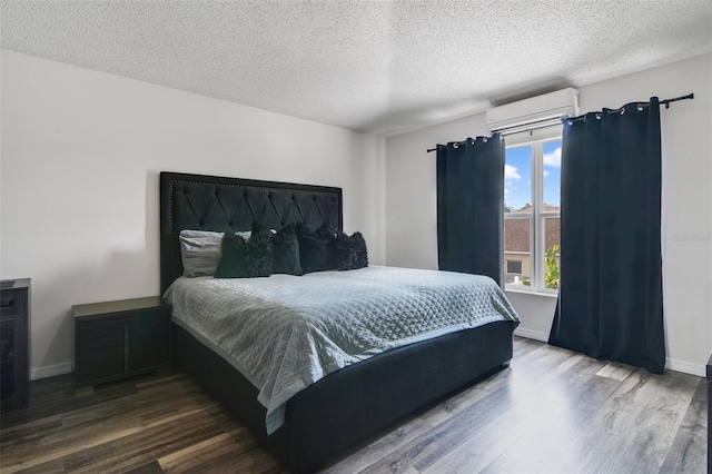 102 Royalty Cir, Sanford, FL 32771 - bedroom featuring a wall unit AC, wood finished floors, a textured ceiling, and baseboards