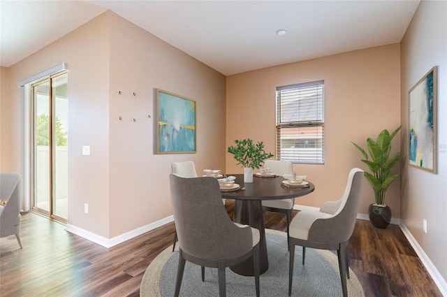 dining space with wood finished floors and baseboards