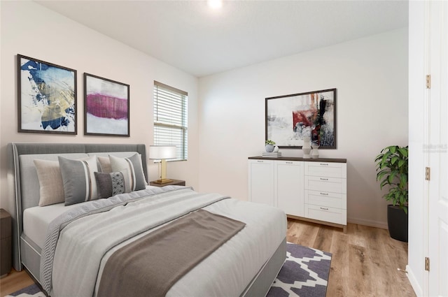 bedroom featuring light wood-type flooring and baseboards