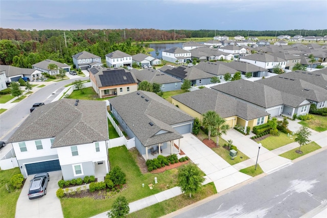 aerial perspective of suburban area featuring a heavily wooded area