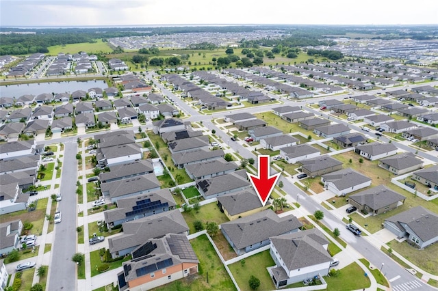 aerial view of property and surrounding area with nearby suburban area