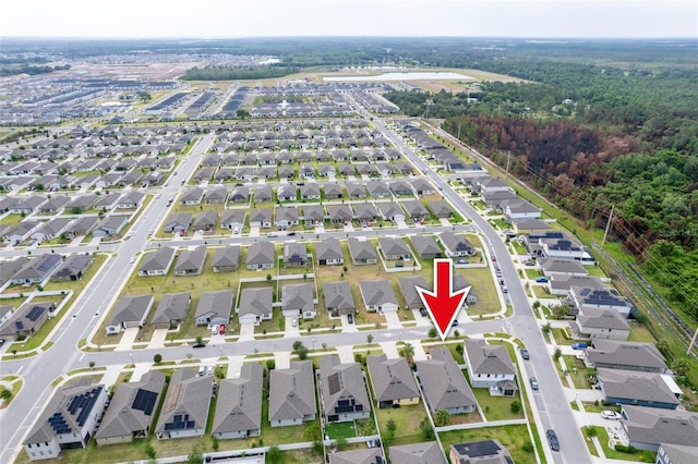 aerial view of property and surrounding area featuring nearby suburban area