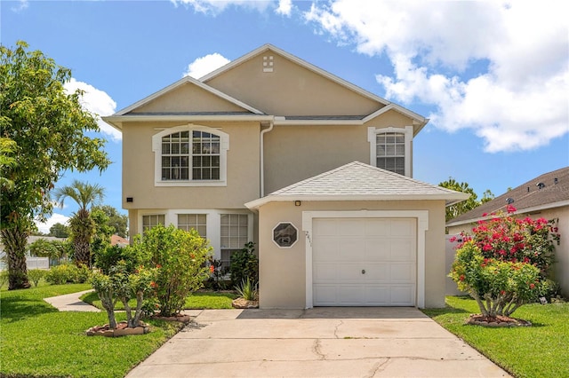 traditional-style home featuring stucco siding, concrete driveway, a front yard, and a garage
