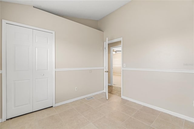 unfurnished bedroom with baseboards and a closet