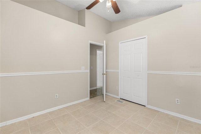 unfurnished bedroom featuring baseboards, a ceiling fan, and light tile patterned flooring