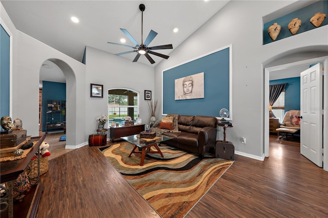 living room featuring ceiling fan, wood finished floors, vaulted ceiling, arched walkways, and recessed lighting