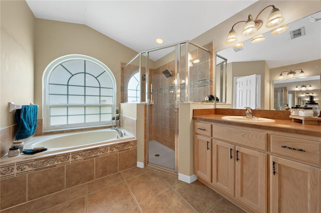 bathroom with tile patterned flooring, a shower stall, a garden tub, and vanity