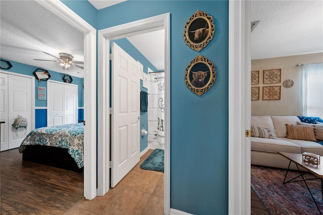 hallway with a textured ceiling and baseboards