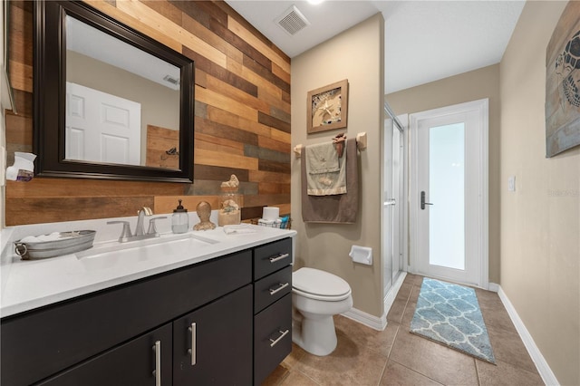 full bathroom featuring toilet, a shower stall, tile patterned floors, vanity, and wooden walls