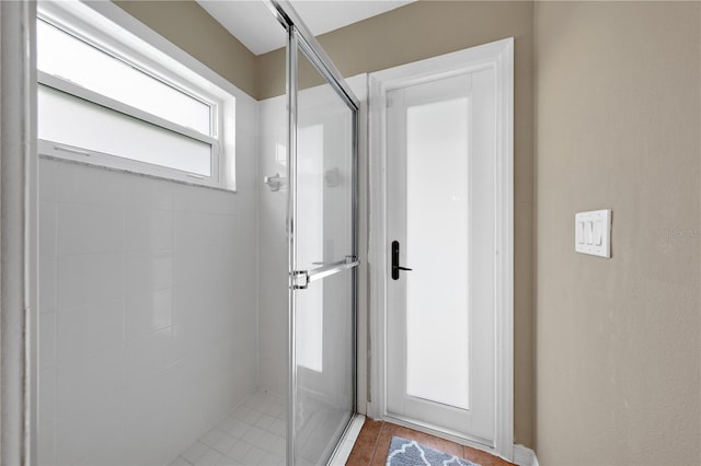 full bathroom with a stall shower and tile patterned floors