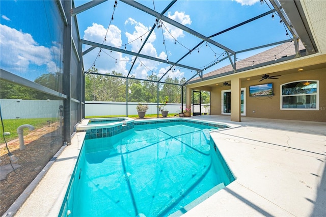 view of pool featuring a ceiling fan, a patio area, a pool with connected hot tub, glass enclosure, and fence