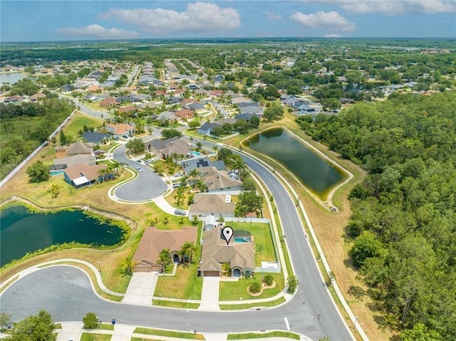aerial overview of property's location with a nearby body of water and nearby suburban area
