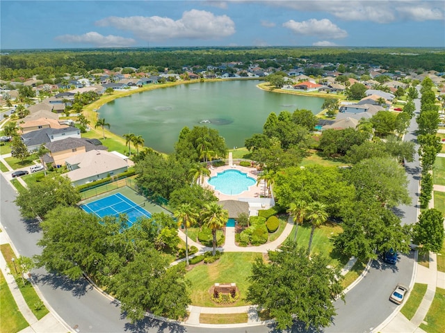 aerial view of residential area with a nearby body of water and a pool area