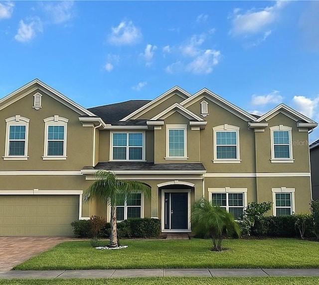 2691 Cypress Tree Trl, Saint Cloud, FL 34772 - view of front of house with stucco siding, a front yard, a garage, and decorative driveway