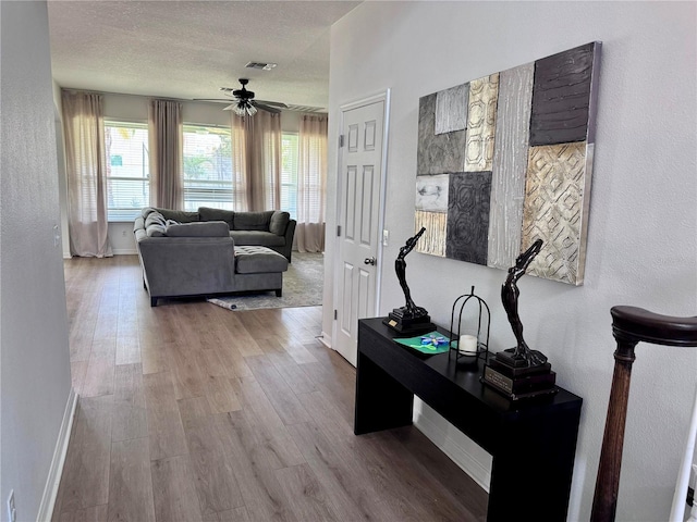 2691 Cypress Tree Trl, Saint Cloud, FL 34772 - corridor with baseboards, wood finished floors, a textured wall, and a textured ceiling