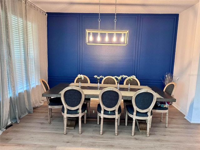 2691 Cypress Tree Trl, Saint Cloud, FL 34772 - dining room featuring wood finished floors, baseboards, and a decorative wall