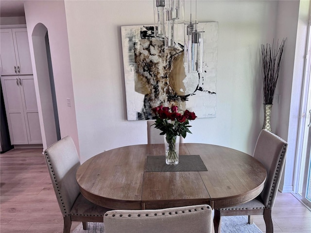 2691 Cypress Tree Trl, Saint Cloud, FL 34772 - dining area featuring light wood-type flooring and arched walkways