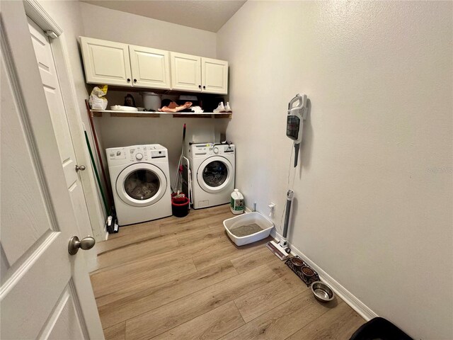 2691 Cypress Tree Trl, Saint Cloud, FL 34772 - laundry room featuring washer and dryer, cabinet space, light wood-style floors, and baseboards