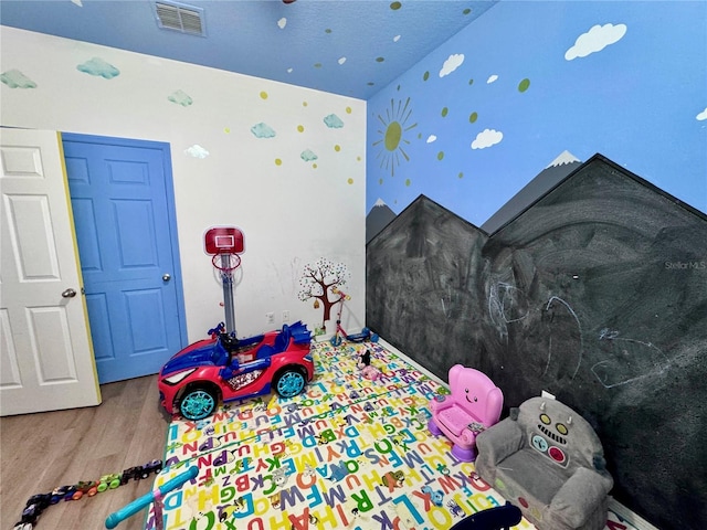 2691 Cypress Tree Trl, Saint Cloud, FL 34772 - rec room with wood finished floors and wallpapered walls