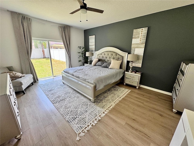 2691 Cypress Tree Trl, Saint Cloud, FL 34772 - bedroom with access to outside, wood finished floors, a ceiling fan, and a textured ceiling