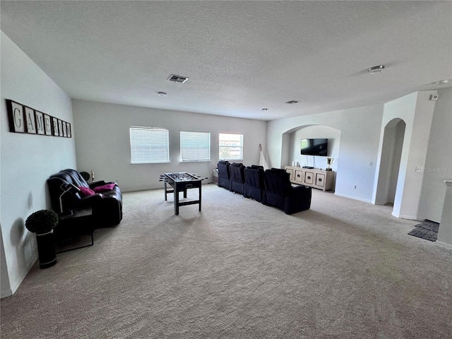 2691 Cypress Tree Trl, Saint Cloud, FL 34772 - living room with arched walkways, carpet floors, a textured ceiling, and baseboards