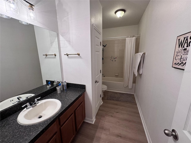 2691 Cypress Tree Trl, Saint Cloud, FL 34772 - full bath featuring wood finished floors, baseboards, vanity, shower / bath combo with shower curtain, and toilet