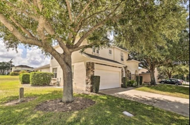 214 Tupelo Cir, Davenport, FL 33897 - view of property hidden behind natural elements with driveway, a garage, a front yard, and stucco siding